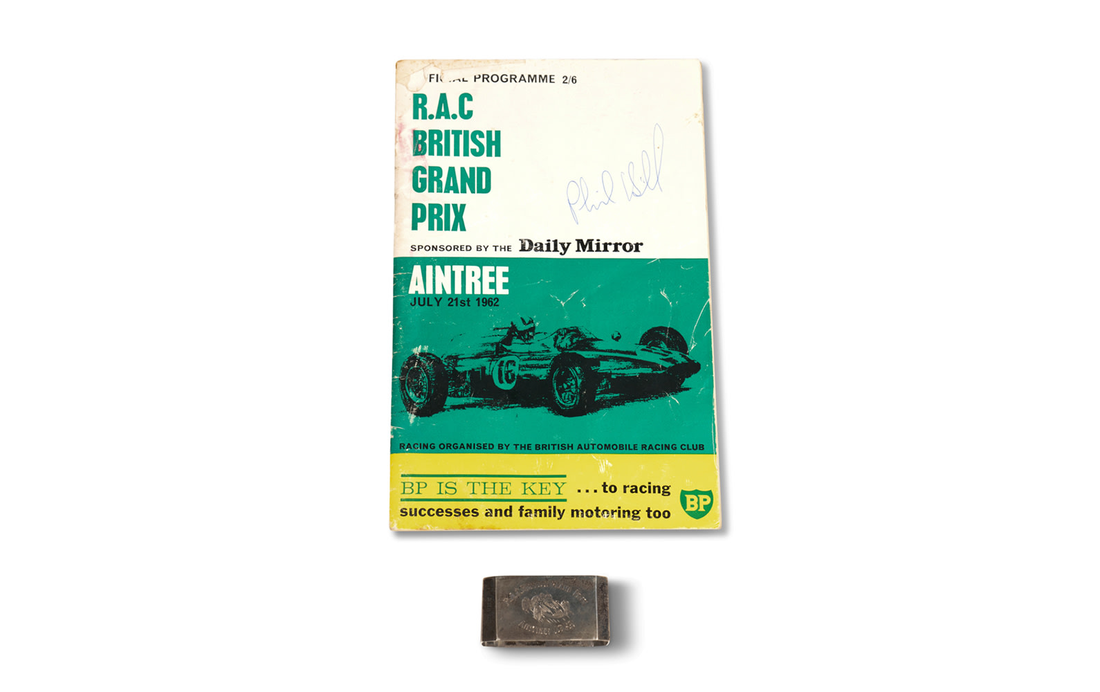 1962 British Grand Prix Official Race Program (Signed by Phil Hill) and Commemorative Silver Napkin Ring