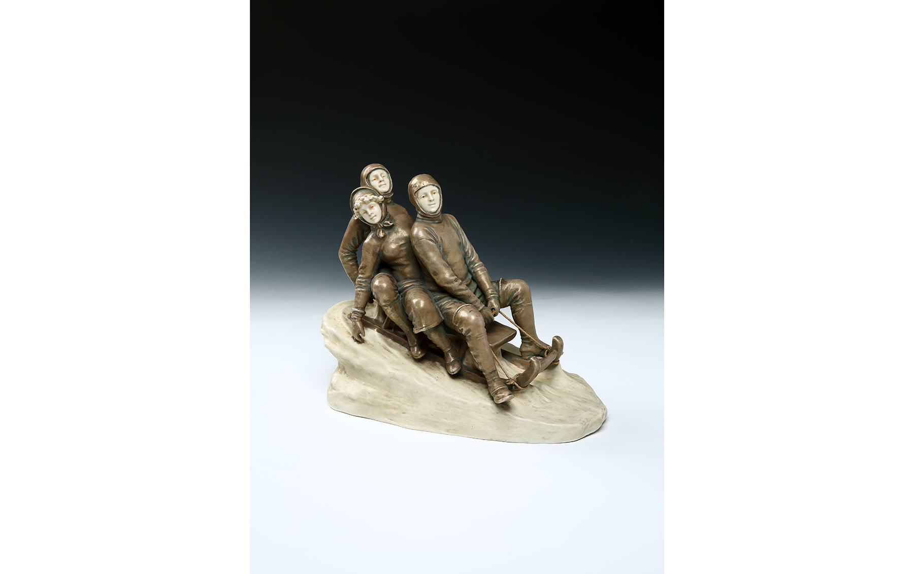 Group of Three Majolica Ceramic Figures on a Wooden Sled, by Theodore Schoop, c. 1910